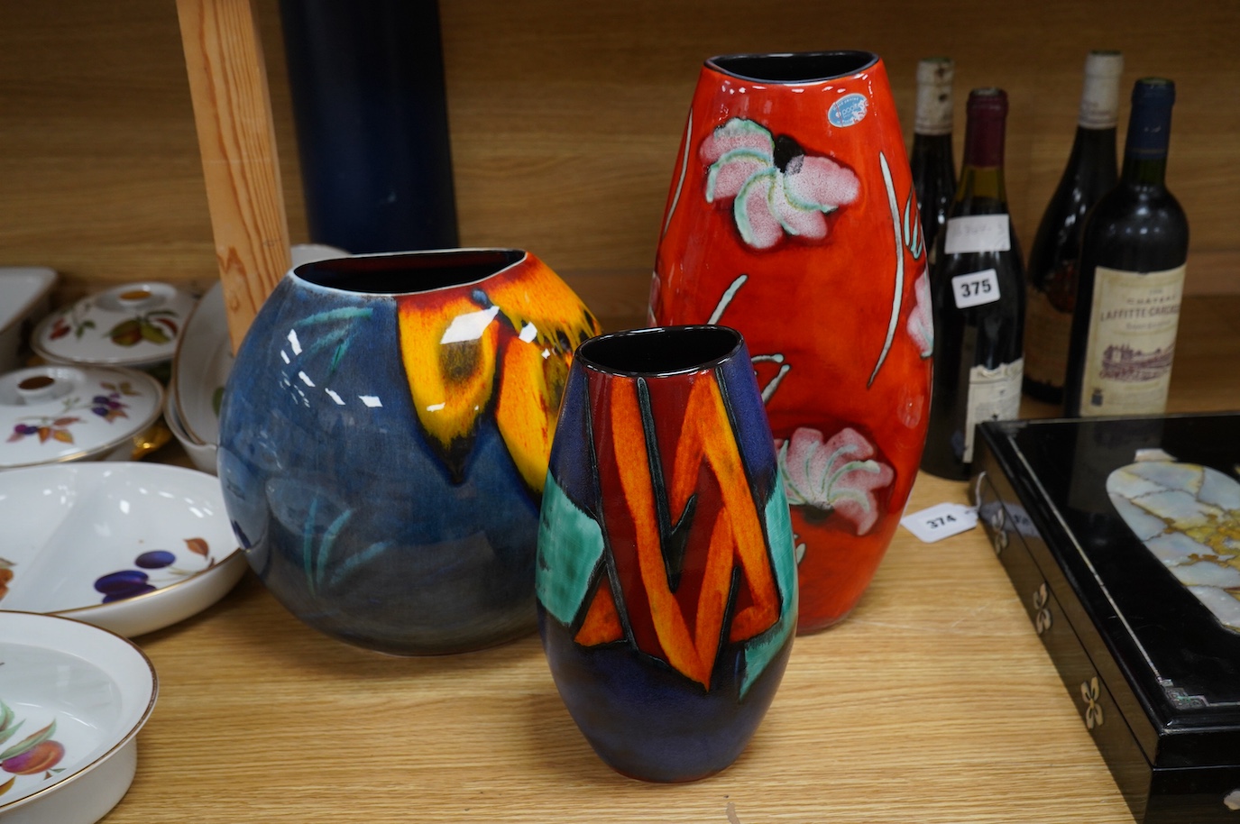 A Poole Purse vase and two Manhattan vases including a ‘daisy’ example, largest 37cm high. Condition - good